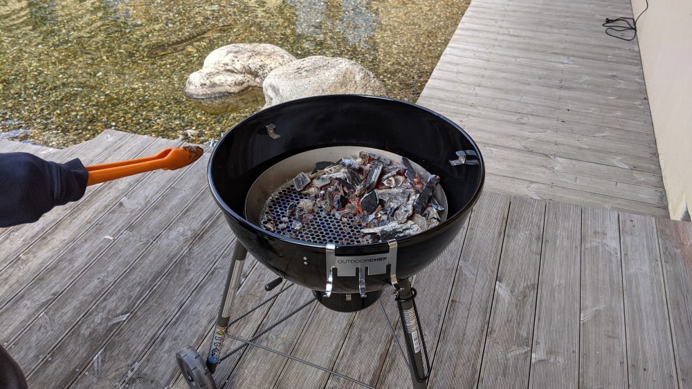 Na čo slúži lievik s polkruhovým výrezom v grile na drevené uhlie Outdoorchef?